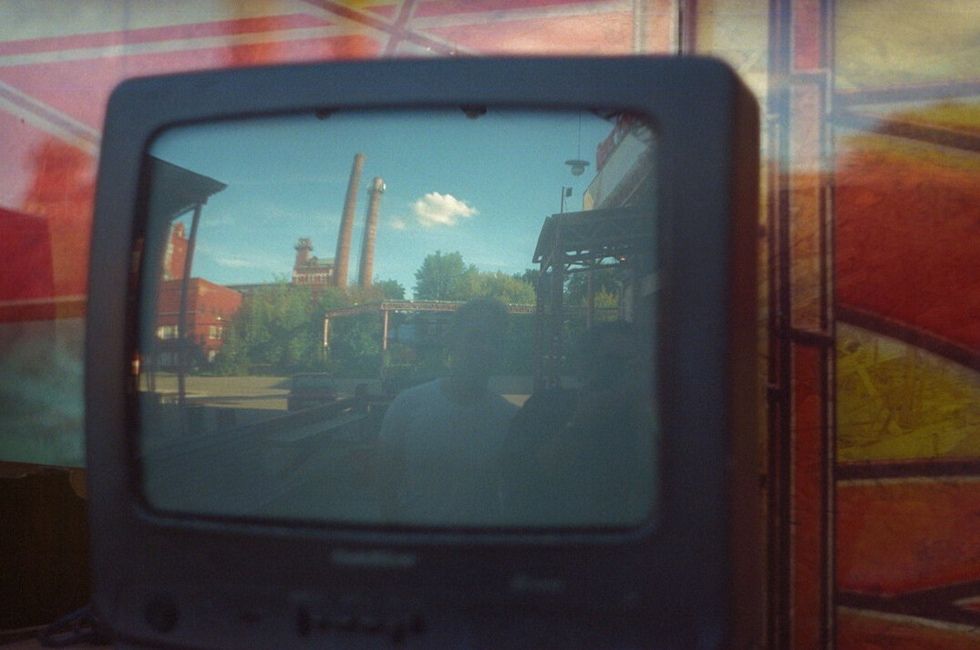 Close-up of control room monitors showing a live broadcast feed